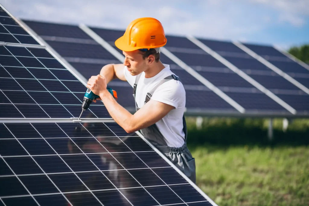 “Solar technician installing photovoltaic panels at a solar power plant”